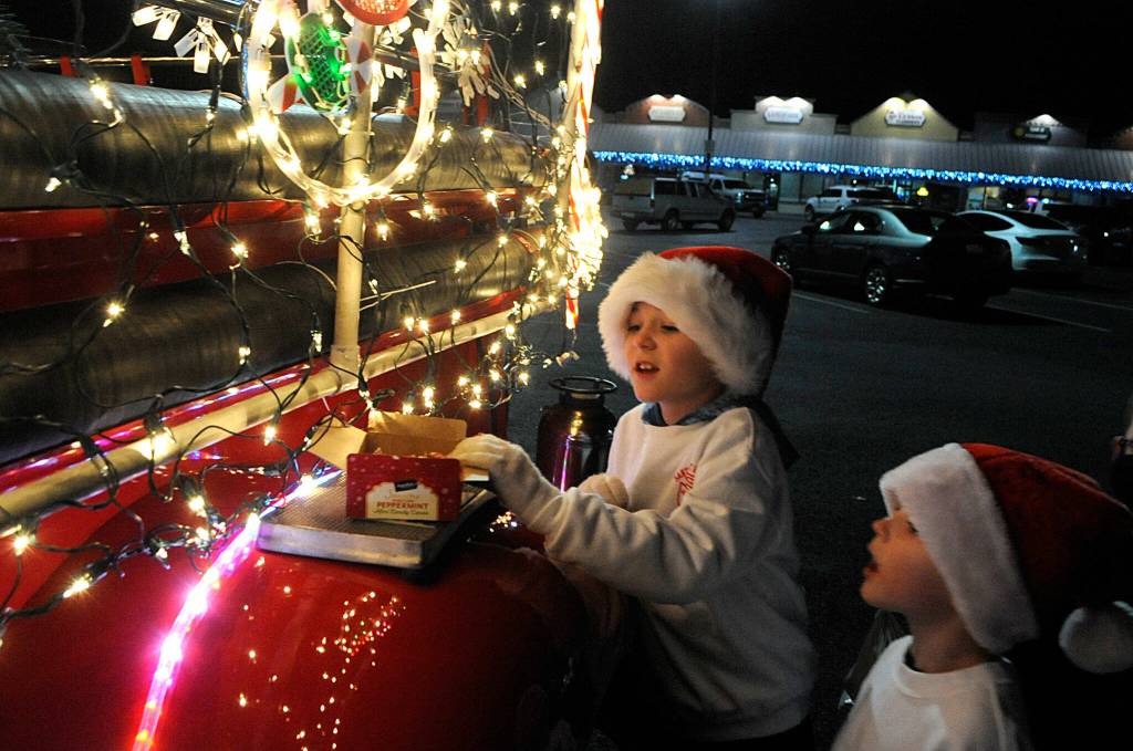 Brothers Connor Horst, 9, and Parker, 7, count the remaining candy canes to help Saint Nicholas during the Santa Brigade collection drive on Dec. 9. Donations went to Sequim Community Aids Toys for Sequim Kids on Dec. 15. Sequim Gazette photo by Matthew Nash