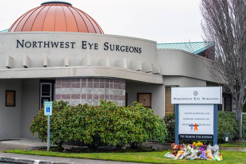 The sign outside Northwest Eye Surgeons in Sequim has become a place for mourners to place flowers in memory of Dr. Matthew Niemeyer, the peninsulas only ophthalmologist, who passed away November 13th from complications of kidney cancer, as symbolized by the ribbons. Sequim Gazette photo by Emily Matthiessen