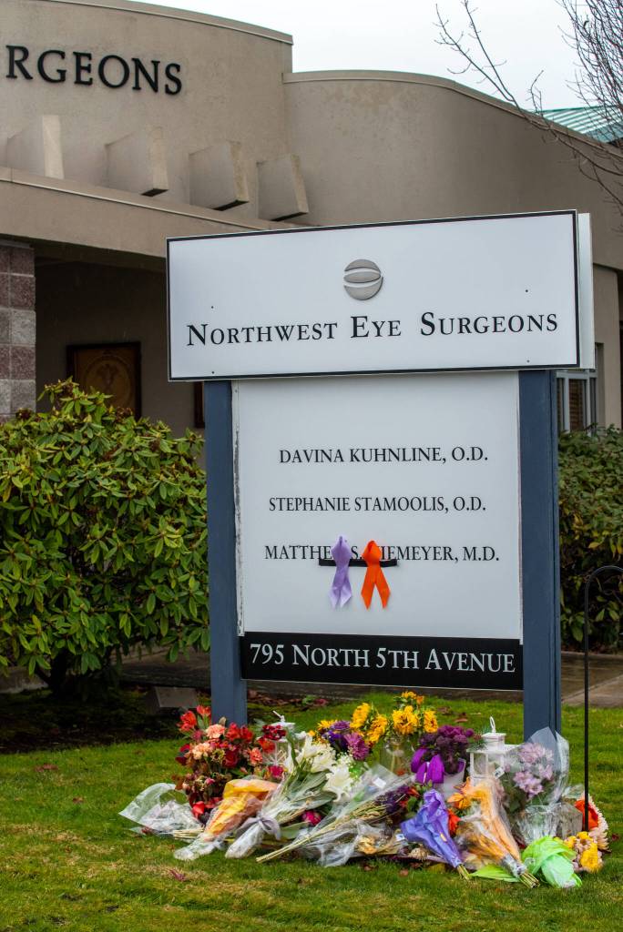 The sign outside Northwest Eye Surgeons in Sequim has become a place for mourners to place flowers in memory of Dr. Matthew Niemeyer, the peninsulas only ophthalmologist, who passed away November 13th from complications of kidney cancer, as symbolized by the ribbons. Sequim Gazette photo by Emily Matthiessen