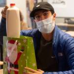 Henry Hughes received some milk for Winter Wishes on Dec. 15. Photo by Charlie Logan