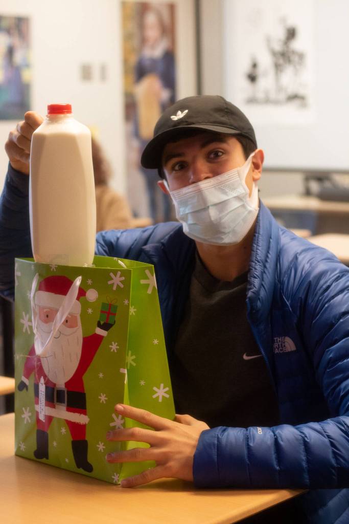 Henry Hughes received some milk for Winter Wishes on Dec. 15. Photo by Charlie Logan