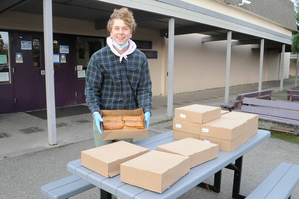 Jack Van De Wege sets out maple bars for students at the Winter Wishes assembly on Dec. 15. Sequim Gazette photo by Matthew Nash