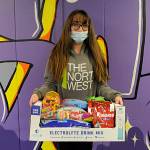 Sophomore Christina Jameson holds up her 30 pounds of candy she received through Sequim High Schools Winter Wishes. Jameson said she and her friends had an inside joke about the mass amount of candy and thought she might get a candy bar. I didnt celebrate Halloween, so this makes up for it, she said. Sequim Gazette photo by Matthew Nash