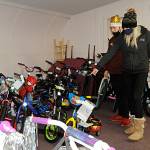 Brandy Brogan picks a bike out at Toys for Sequim Kids with help from volunteer Ryan Cherry, a Church of Jesus Christ of Latter-day Saints missionary, for a chance to receive one of 34 bikes in Sequim Community Aids raffle. Sequim Gazette photo by Matthew Nash