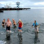 Participants in the 2021 Port Angeles Polar Bear Dip emerge from the chilly water at Hollywood Beach in port Angeles.  Although there was no organized event last year due to COVID-19 restrictions, many people showed up anyway to run to take part in the annual ritual. This year's event is set for Saturday, Jan. 1. File photo by Keith Thorpe/Olympic Peninsula News Group