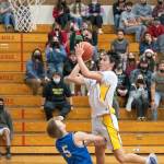 Sequims Isaiah Moore, right, drives in for a basket in the Wolves 61-50 win over North Mason on Dec. 16. Moore and Keenan Green led the team with 15 points apiece. Sequim Gazette photo by Emily Matthiessen