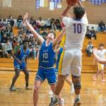 Top: Sequims Isaiah Moore, right, drives in for a basket in the Wolves 61-50 win over North Mason on Dec. 16. Moore and Keenan Green led the team with 15 points apiece. Bottom: Sequims Pryce Glasser, right, puts up a shot over North Masons Nick Minaker. Sequim Gazette photos by Emily Matthiessen