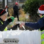 Becky Roberts, left, and Ann Flack, president of the Sequim Sunrise Rotary, fill bags for Decembers Family Holiday Meal Bag program. The Rotarians were one of many groups participating in the even on Dec. 17. Sequim Gazette photo by Matthew Nash