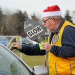 David Blakeslee, vice-president of the Sequim Valley Lions Club, hands out a $15 gift card to Walmart during the December Family Holiday Meal Bag program in Carrie Blake Community Park. He was one of 11 Lions to help on the day. Sequim Gazette photo by Matthew Nash