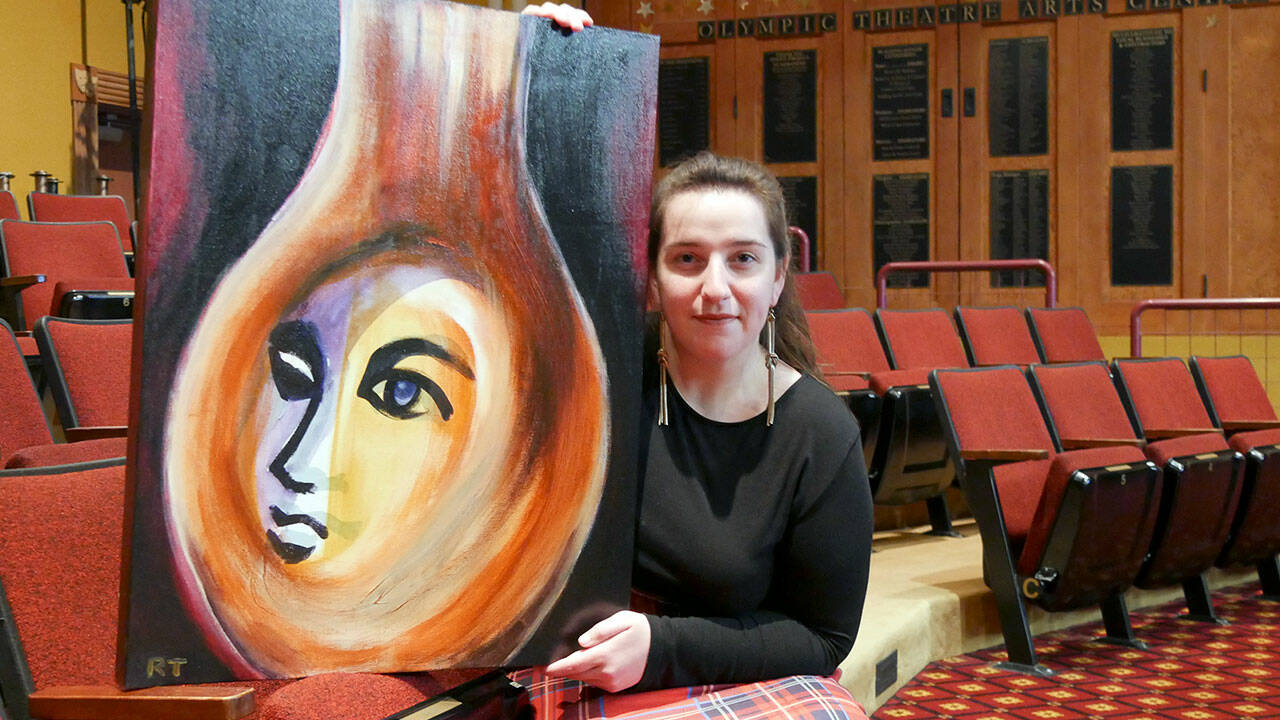 Photo courtesy of Olympic Theatre Arts
Director Ginny Holladay holds artwork for Angel Street that was created and donated by Ryoko Toyama.