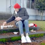 Keith Thorpe/Peninsula Daily News
Michael Freestone of Port Angeles sits on the steps in front of the Salvation Army Church in Port Anageles as he enjoys a carry-out Christmas Eve lunch. The organization served dozens of lunches with an outdoor dining twist in its annual holiday tradition.