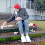 Photo by Keith Thorpe/Olympic Peninsula News Group
Michael Freestone of Port Angeles sits on the steps in front of the Salvation Army Church in Port Angeles as he enjoys a carry-out Christmas Eve lunch. The organization served dozens of lunches with an outdoor dining twist in its annual holiday tradition.