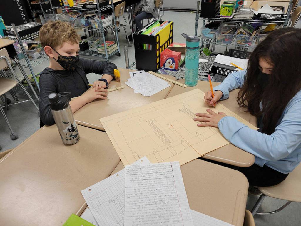 Zachary Gullick and Jasline Romo, fifth-graders in Saxon Holt's class at Helen Haller Elementary School, draw schematics on a medieval castle. Submitted photo