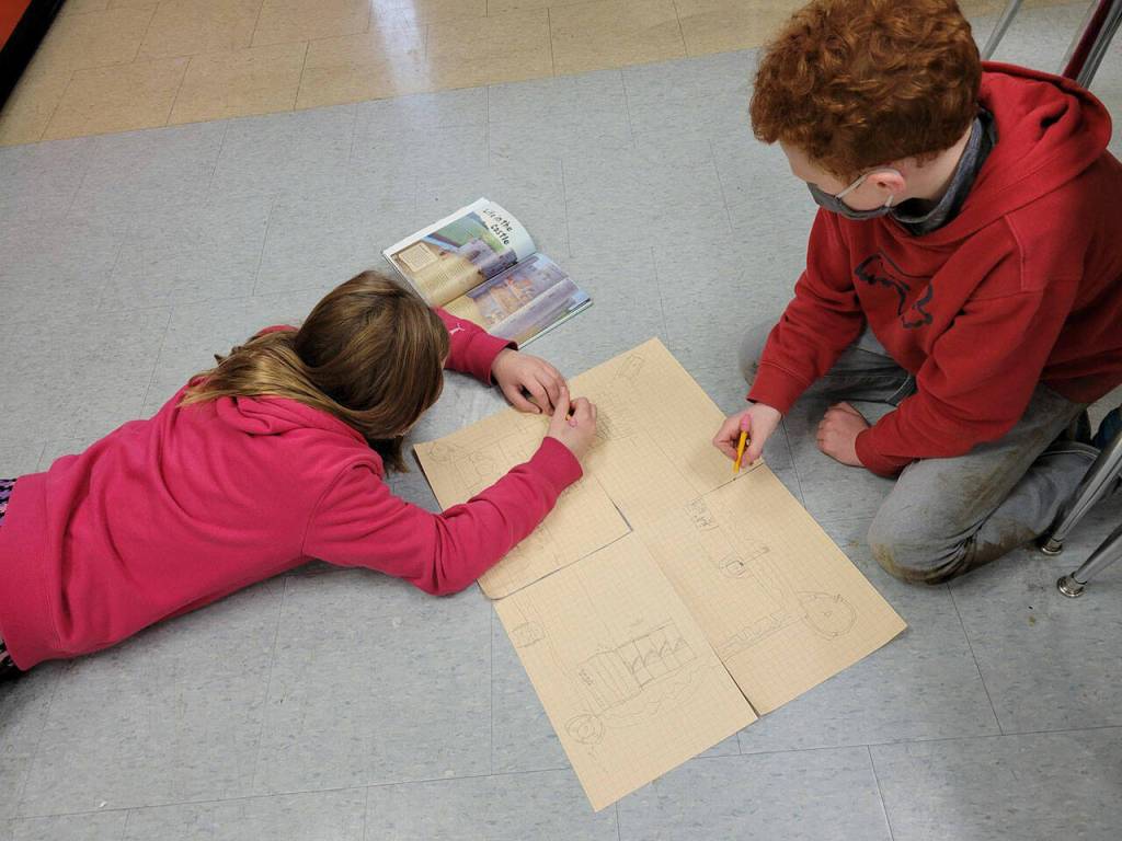 Zoei McCullem, left, and Kyler Read, fifth-graders in Saxon Holt's class at Helen Haller Elementary School, draw schematics on a medieval castle. Submitted photo