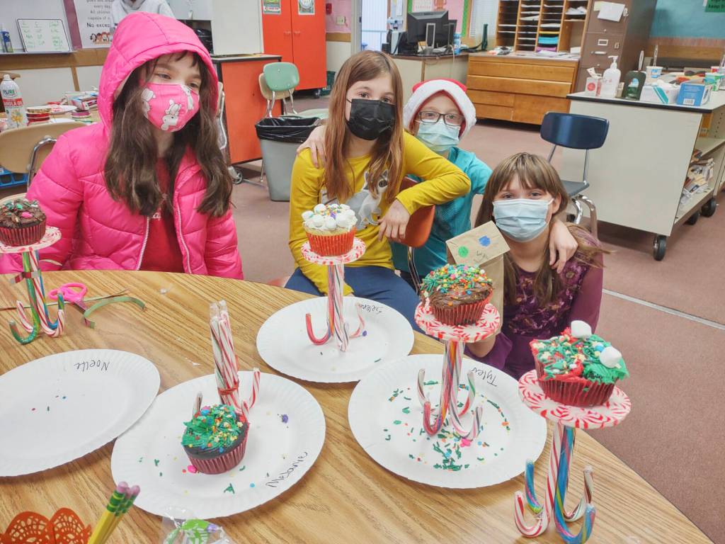 Students in Heather Rileys class earn Fun Day Friday through positive behavior in the classroom and task completion. They recently voted for Culinary Delight. They created candy cane pedestals to hold the cupcakes they baked and decorated. They also made a paper bag gingerbread house to hold their candy pedestals. Pictured are, from left, are Noelle Coonelly, Selen Dorkin, Dalton Wilkinson and Kendallmarie Broman. Submitted photo
