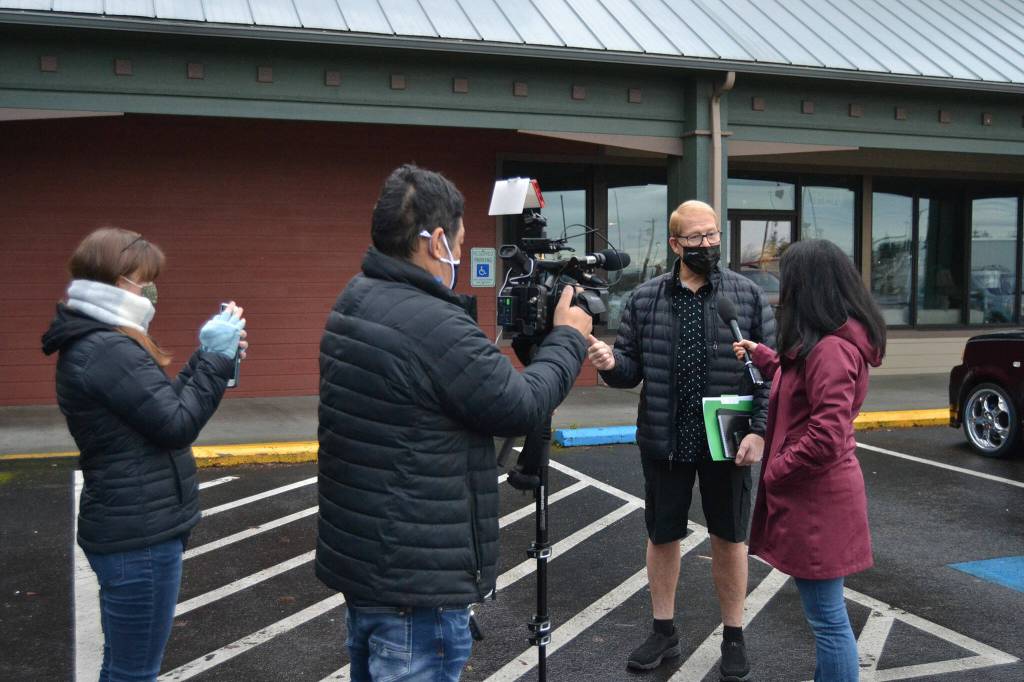 CNN's senior national correspondent Kyung Lah interviews Sequim mayor William Armacost after a Coffee with the Mayor session on Jan. 28 about QAnon as producer Kim Berryman and photojournalist Taka Yokoyama and record the conversation that appeared on a segment of "Anderson Cooper 360" the next night. Armacost said he never publicly supported QAnon. Sequim Gazette photo by Matthew Nash