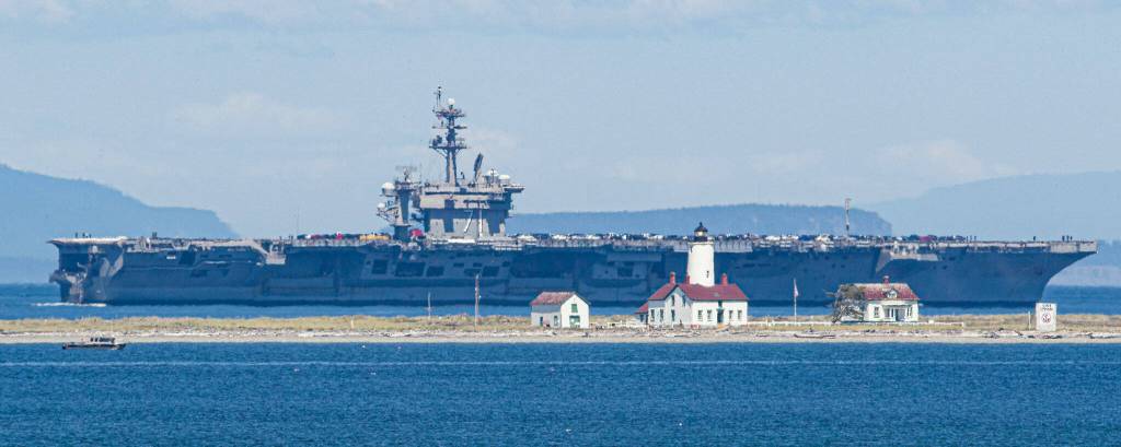 Sequim photographer Keith Ross snapped some shots of the USS Teddy Roosevelt on July 22 as it passed the New Dungeness Lighthouse. His image was shared later on King5 news, he said. The U.S. Navy ship, along with 2,500 sailors and their families, are calling the Puget Sound their new home for the next year and a half at  Naval Base Kitsap in Bremerton. For prints, visit keithsframeofmind.com/proofing/landscape. 
Photo by Keith Ross/ Keith’s Frame of Mind