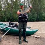 Photo courtesy of WDFW
New rafts donated to Washington Department of Fish & Wildlife were used to great effect this summer, fishing advocates say, providing the means to effectively patrol smaller rivers. On a day when a number of citations for violations were written, WDFW officer Patrick Murray holds up a wild chinook an angler had kept after cutting off the adipose fin.
