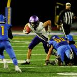 Sequim running back Aiden Gockerell, center, tries to break free from Bremerton defenders (from left) in the first half of the Wolves 35-29 loss at Bremerton on Sept. 30. Sequim Gazette photo by Michael Dashiell