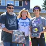 Sequim Little League softballer Mia Kirner, right, accepts the Don Knapp Sportsmanship Award from Tony and Brenda Knapp Bistline on July 10 at the leagues season-ending ceremonies. In part to honor the legacy of longtime volunteer/advocate Don Knapp, who passed away in November 2020, the league created the sportsmanship award for one baseball player and one softball player. Kirner and baseballer Bryant Laboy (who received the award at a separate ceremony) are the first recipients. Sequim Gazette photo by Michael Dashiell