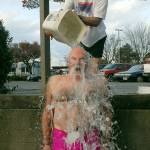 Bruce Monro of Port Angeles reacts to the shock of having a bucket of ice water poured on him by Dan Welden of Port Angeles at the conclusion of the annual Polar Bear plunge on New Years Day at Port Angeles Hollywood Beach. Although there was no organized plunge due to COVID-19 restrictions, many people showed up anyway to run into the chilly water of Port Angeles Harbor. Photo by Keith Thorpe/Olympic Peninsula News Group