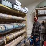 David Brownell, North Olympic History Center Executive Director, stands near rolls of heirloom quilts sewn by ancestors on the peninsula.