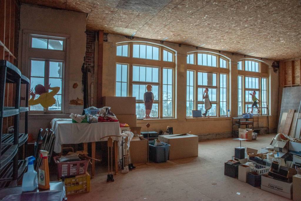 Paintings of children by Port Townsend artist Pat Gallup are frozen in perpetual childhood on the windows of the old Lincoln School in Port Angeles, which closed in 1978 and was bought by the North Olympic History Center in 1991. Sequim Gazette photo by Emily Matthiessen