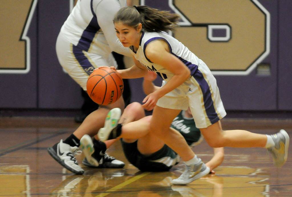 Sequim guard Taryn Johnson steals the ball from a Port Angeles player in the second half of the Wolves 60-55 home win over PA on Jan. 11. Sequim Gazette photo by Michael Dashiell