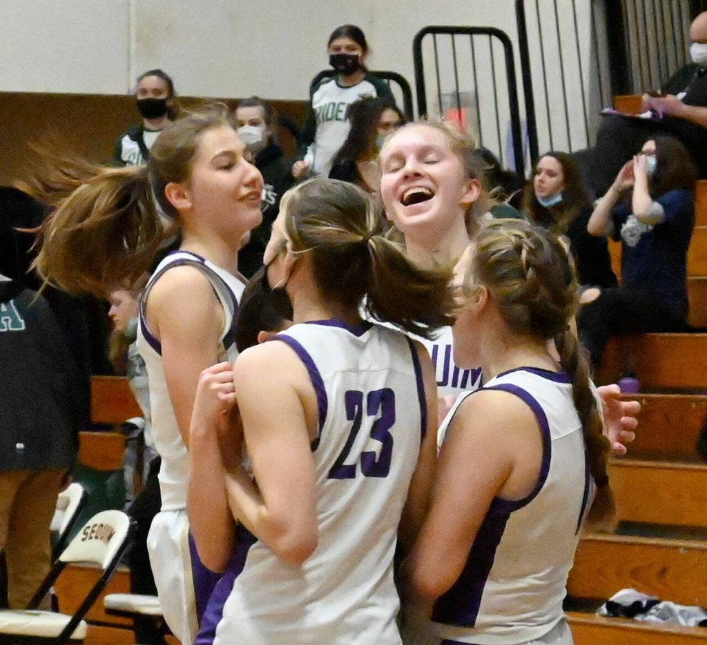 Sequim players celebrate a 60-55 win at home over rival Port Angeles, their first win over the Roughriders in six seasons  ending a 14-game Rider win streak. Sequim Gazette photo by Michael Dashiell