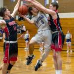 Sequim Gazette photo by Emily Matthiessen
Sequims Tyler Mooney, center, looks for a basket in the midst of Crosspoint defenders in the Wolves 63-62 non-league home loss on Jan. 14.