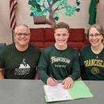 Photo by Dave Ditlefsen/Sequim High School
Sequim High senior Aidan Henninger signs a letter of intent to play for NCAA Division III Franciscan University of Steubenville, Ohio, on Jan. 21. Here he is pictured with parents Ray and Ann Marie Henninger.