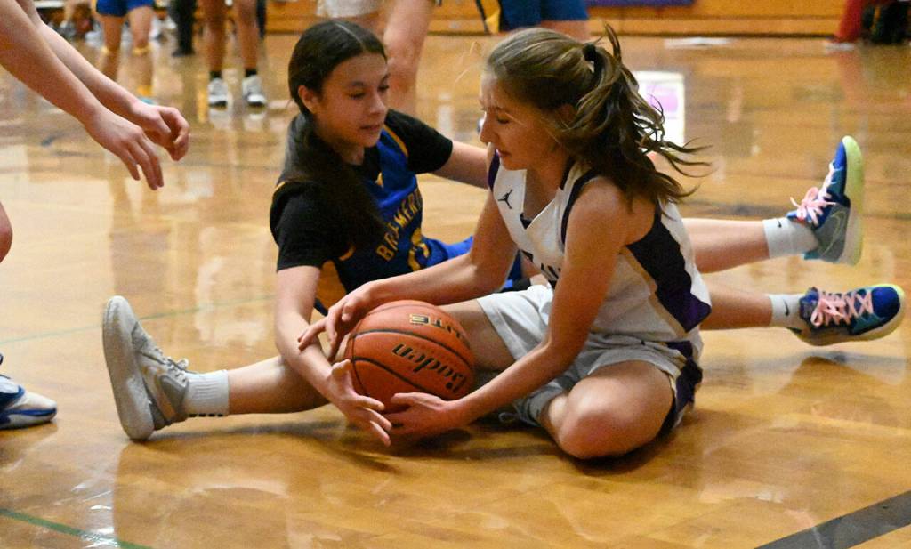 Sequim guard Taryn Johnson, right, snatches the ball from Bremertons Annisa Mejia in the Wolves Olympic League win on Jan. 20 at home. Sequim Gazette photo by Michael Dashiell
