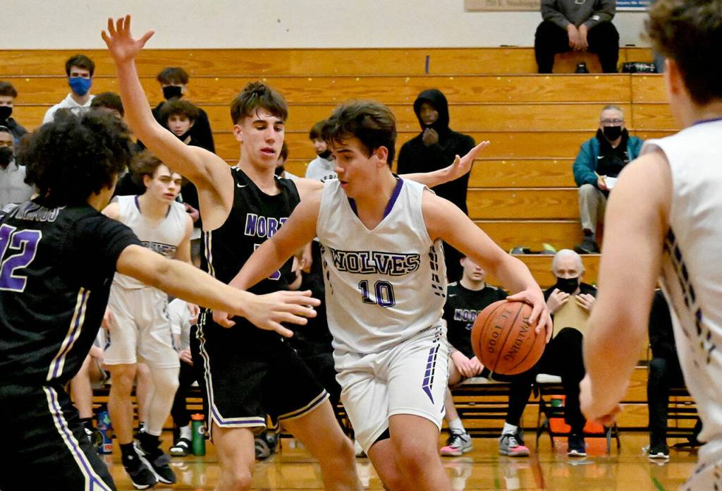 Sequims Pryce Glasser looks for room to drive the lane as he and the Wolves take on top-ranked North Kitsap on jan. 20. Glasser had 14 points in the 78-40 loss. Sequim Gazette photo by Michael Dashiell