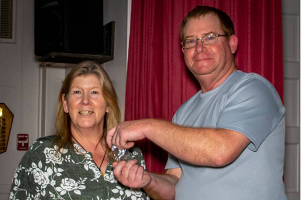 Dave McDaniels, Sequim Prairie Grange president, honors Kim Moulson for 45 years of membership with the Grange. Photo by Sherrie Cerutti