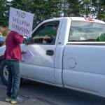 Jane Erickson speaks with a drive entering the Dungeness National Wildlife Refuge on Oct. 2, 2021, during a protest against a future oyster farm at the refuge in Sequim. Sequim Gazette photo by Emily Matthiessen
