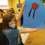 Kindergartener Bard Sweeney, a student in Lorrie Corders class at Helen Haller Elementary, shows off some artwork as she and others celebrate and study Martin Luther King Jr. in January. Submitted photo