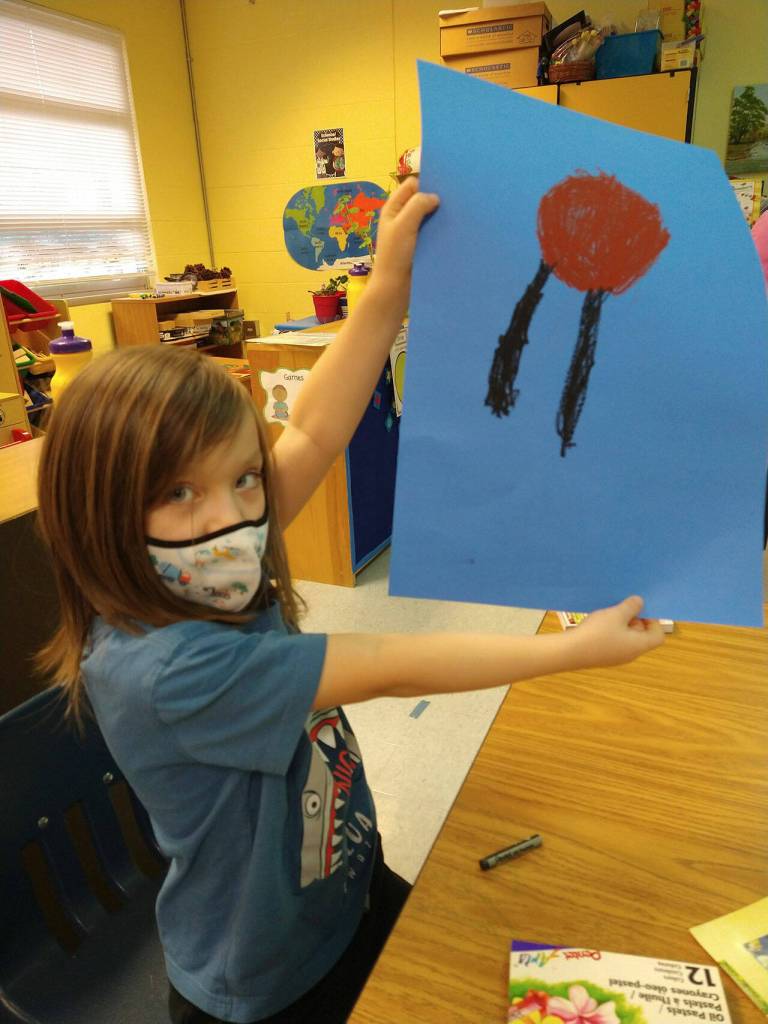 Kindergartener Bard Sweeney, a student in Lorrie Corders class at Helen Haller Elementary, shows off some artwork as she and others celebrate and study Martin Luther King Jr. in January. Submitted photo