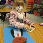 Ma-KenaLei Dickinson, a student in Lorrie Corders kindergarten class at Helen Haller Elementary, shows off some artwork as she and others celebrate and study Martin Luther King Jr. in January. Submitted photo