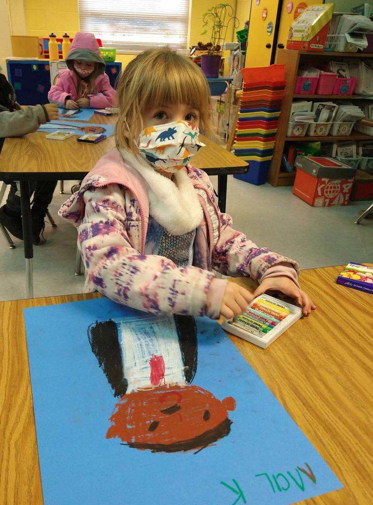 Ma-KenaLei Dickinson, a student in Lorrie Corders kindergarten class at Helen Haller Elementary, shows off some artwork as she and others celebrate and study Martin Luther King Jr. in January. Submitted photo