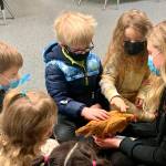 Kindergartners (from left) Novalee Bruni, Alex Fazio, Asher Gilliam and Avyn LaTourette visit with fifth-grader Kendall Adolphe and her chicken. Submitted photo