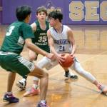 Sequims Jayden Possin, with basketball, is trapped by Port Angeles Quanah Wheeler, left, and Parker Nickerson during the Wolves 62-49 home loss on Feb. 3. Sequim Gazette photo by Emily Matthiessen