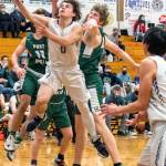 Sequim Gazette photo by Emily Matthiessen
Sequims Tyler Mooney puts up a layup while defended by Port Angeles Xander Maestas, at left, and John Vaara during the Wolves 62-49 loss on Feb. 3.