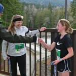Elwha Bridge 5k champ Leia Larson, 13, of Port Angeles, gets congratulated at the finish line as she talks with runner-up Shannon Newman of Maple Valley.