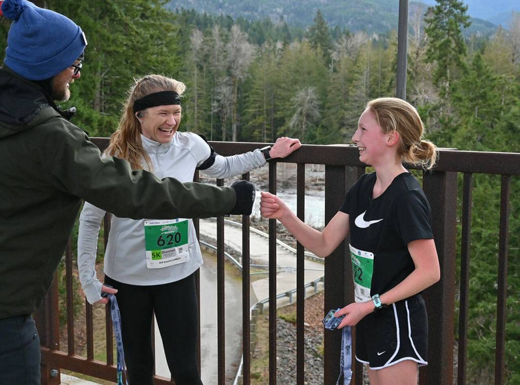 Elwha Bridge 5k champ Leia Larson, 13, of Port Angeles, gets congratulated at the finish line as she talks with runner-up Shannon Newman of Maple Valley.