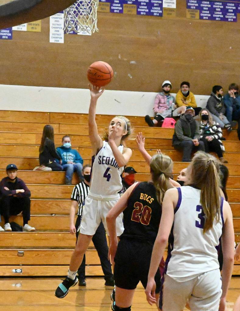 In a Feb. 8 non-league game in Sequim, Sequims Hannah Wagner (4) puts up a shot as Kingstons Ellee Brockman (20) and Sequims Jolene Vaara look on. Sequim Gazette photo by Michael Dashiell