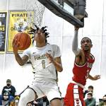 Peninsula's Michael Medlock, left, drives past Skagit's Lezjuan Harris for a score in the Pirates' 83-69 upset of the visiting Cardinals on Feb. 16. Medlock had 15 points off the bench. Photo by Jay Cline/Peninsula College