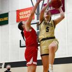 Sequim native Hope Glasser, right, drives to the basket as Skagit Valley's Madison Plautz in the Pirates' 64-47 home win over the Cardinals on Feb. 17. Glasser led the team with 19 points. Photo by Jay Cline/Peninsula College