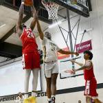 Peninsula's Isaiah Sampson, center, battles with Skagit Valley's Etan Collins for a rebound in the Pirates' 83-69 home win over Skagit on Feb. 17. Sampson led PC with 16 points. Photo by Jay Cline/Peninsula College