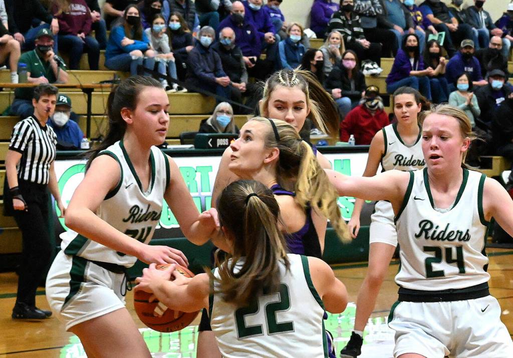 Sequims Hannah Wagner, center, knifes through the Port Angeles defense to put up a shot in the first half of a West Central District playoff game on Feb. 17. Wagner later left the game with a knee injury. Sequim Gazette photo by Michael Dashiell