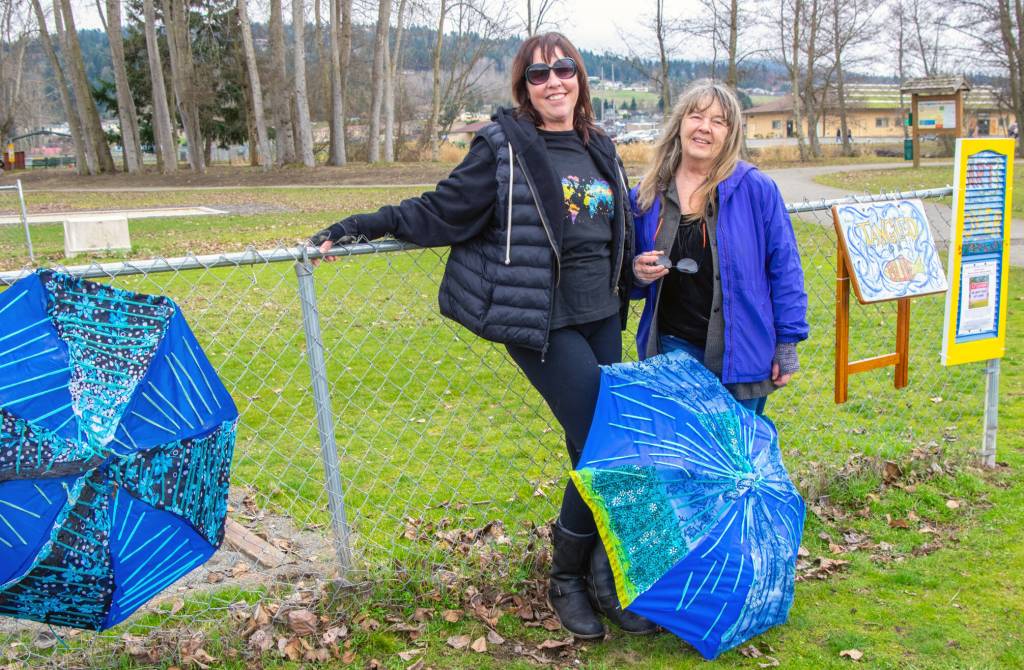 Sequim Gazette photo by Emily Matthiessen
Brigitte Schlemmer and Suzanne Horne hung the first pieces for Art All Over  The Art Show Without Walls, this past weekend at Carrie Blake City Park. Submissions will be accepted for months in the hope that more people will submit their art for hanging in Sequim city parks.